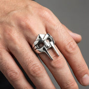 Model wearing a heavy Sterling Silver MF DOOM Mask Ring on finger, showcasing the detailed gladiator villain face design in a hip hop biker jewelry style.