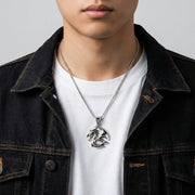 Man wearing a solid 925 sterling silver tribal dragon pendant necklace, showcasing the detailed gothic design and size appropriate for mens jewelry fashion