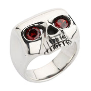 A minimalist skull ring in solid sterling silver, featuring a high-polish finish and two large red garnet CZ eyes.