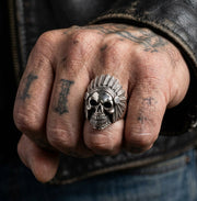 A handcrafted Native American skull ring in .925 sterling silver, shown worn on a man's hand.