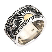 A solid sterling silver Native American style ring with a beautiful brass sun inlay and two intricately engraved eagles.