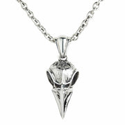 A solid sterling silver Norse raven skull pendant with a brilliant, polished beak and detailed, textured cranium.