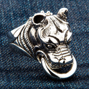 An angled view of the heavy sterling silver pitbull knocker ring on denim.