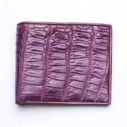 Front view of a men's bifold wallet crafted from genuine crocodile leather in a deep plum purple tone.