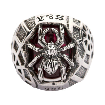 Front view of the spider perched on a red gemstone ring