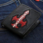 A front view of the handmade black lizard skin wallet featuring a red stingray leather cross inlay.