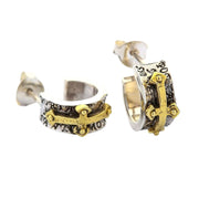 A pair of men's rocker cross earrings in sterling silver with prominent gold-plated crosses