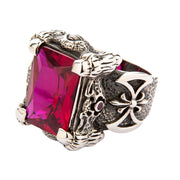 A large sterling silver dragon claw ring holding a massive rectangular ruby-red stone on a white background.