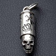 A solid sterling silver skull bullet pendant with detailed and intricate crown and cross engravings.
