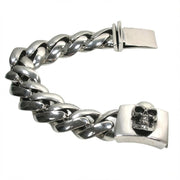 Detailed view of 3D skull clasp on heavy curb chain sterling silver bracelet