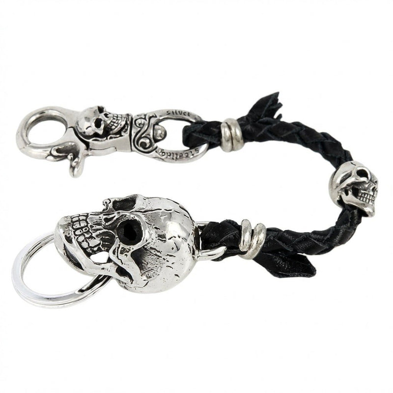 Full view of the sterling silver skull keychain wallet holder featuring a black braided leather strap and large skull accent