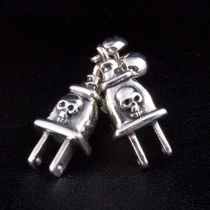 Pair of skull power plug sterling silver drop earrings showing detailed skull design on polished silver
