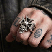Model wearing the Sterling Silver Iron Cross Ring with Dangle Skull on hand