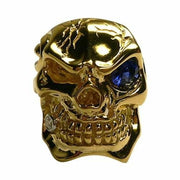A massive, solid 14K yellow gold skull ring, expertly set with a large natural blue sapphire eye and a genuine diamond tooth.