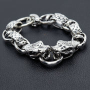 Sterling sølv anaconda slange armbånd med dobbelte slangehoveder, der griber ringens midtpunkt