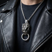 Man wearing heavy sterling silver boar pendant on leather necklace with biker jacket