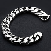 A heavy 14mm sterling silver Cuban link bracelet with a high polish finish resting on a black surface.