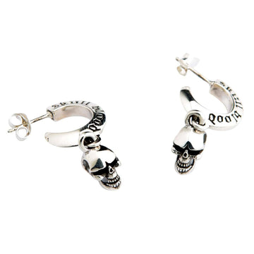 A premium pair of solid sterling silver dangle skull earrings with intricately engraved hoops, shown on a dark denim background.