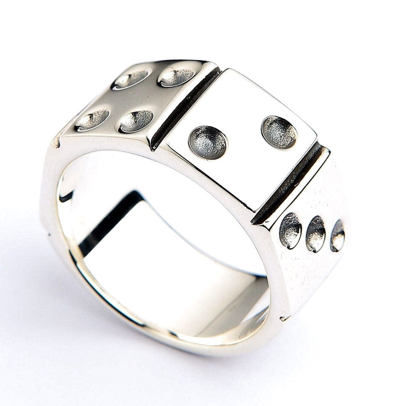 Angled view of a polished sterling silver band featuring recessed dice faces with carved pips standing in relief