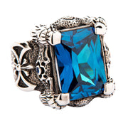 A gothic-style sterling silver dragon claw ring, featuring a rugged, scaly band and a 36-carat blue topaz CZ stone.