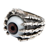 A front view of the sterling silver eyeball ring, showing the realistic brown eye held in a detailed skeleton claw.