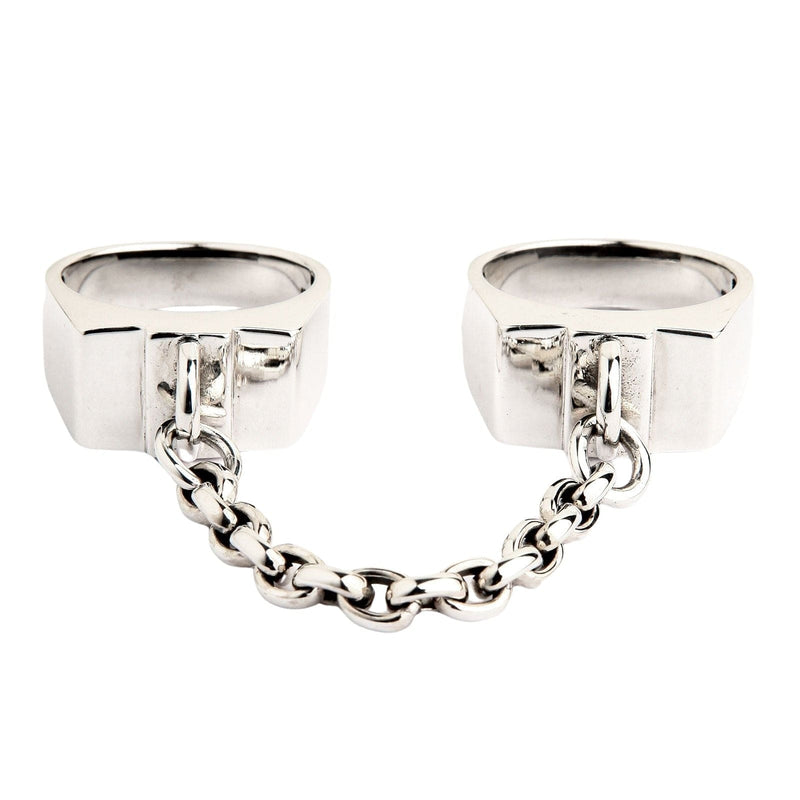 A front view of the sterling silver handcuff rings connected by a chain, isolated on a white background.
