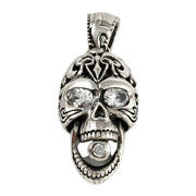 Sterling silver laughing skull pendant featuring an open jaw, tribal engravings, and clear CZ stones in the eyes and mouth.