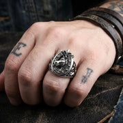 Sterling silver medieval horse and horseshoe ring worn on tattooed hand with leather bracelet