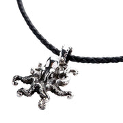 A solid sterling silver octopus pendant with detailed tentacles, shown on a braided leather necklace.