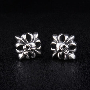 A pair of sterling silver skull and crossbones stud earrings with gothic filigree details, on a black background.
