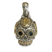 Front view of sterling silver sugar skull pendant with brass Virgin Mary forehead accent and blue topaz eye.