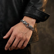 Men's tiger head sterling silver bracelet worn on wrist with black leather jacket