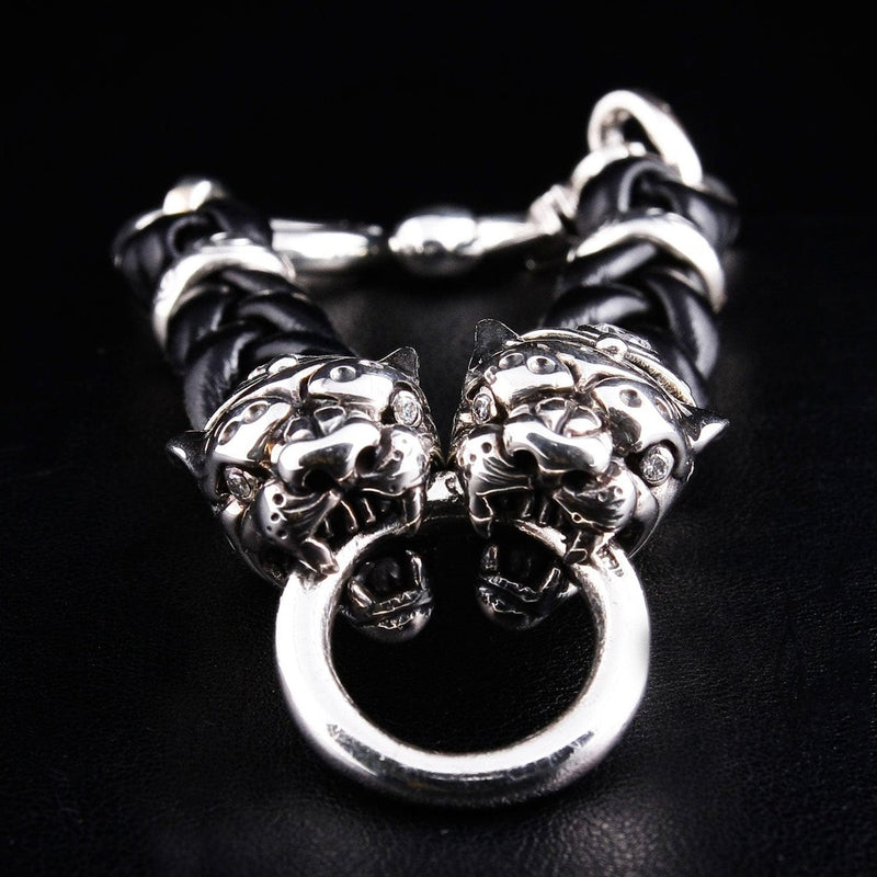 Tiger head sterling silver bracelet front view showing dual tiger heads gripping silver ring