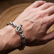 Tribal floral silver bracelet worn on wrist lifestyle photo showing masculine jewelry style