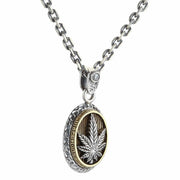 A two-tone cannabis pendant in sterling silver and brass