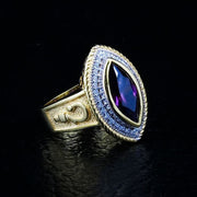 An angled view of the women's gold amethyst bishop ring, showing the crosier symbol on the 14K gold-plated band.