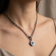 Close-up of a woman wearing a pendant necklace measuring 10mm x 17mm including bail