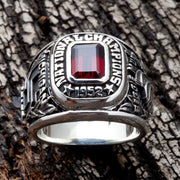 A front view of the 1952 Michigan State National Champions ring on a wood background.