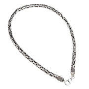 A heavy 7mm sterling silver Byzantine necklace with ornate end caps and a lobster clasp.