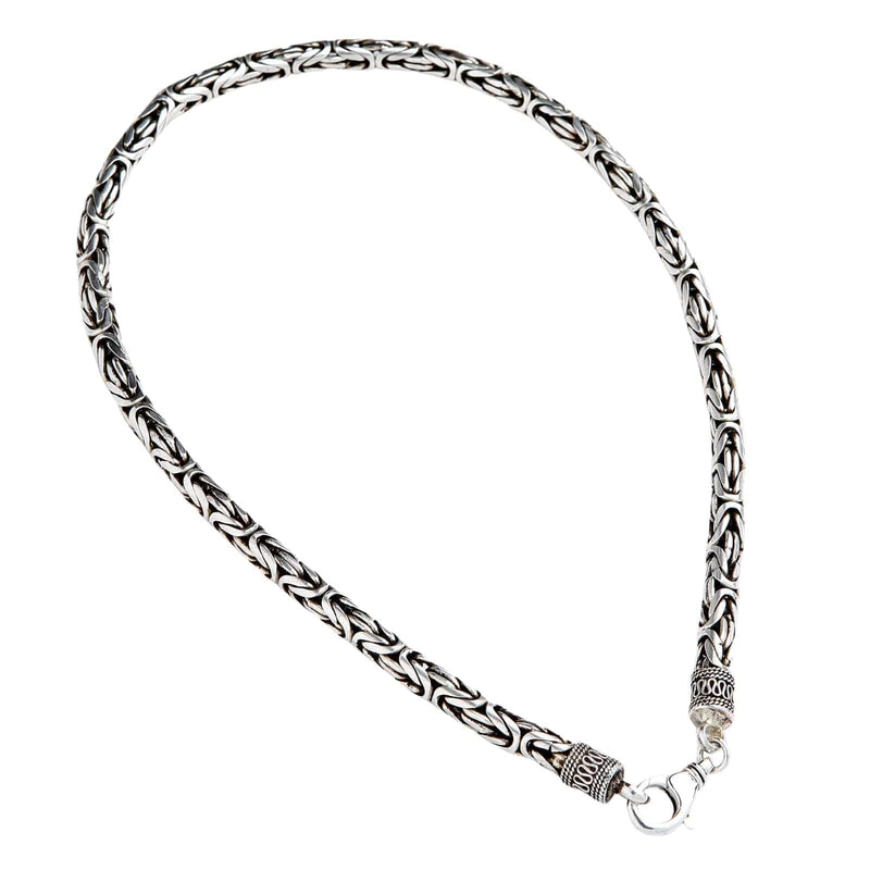 A heavy 7mm sterling silver Byzantine necklace with ornate end caps and a lobster clasp.