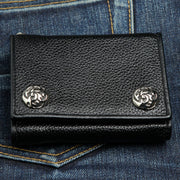 A black genuine leather biker wallet with two ornate, silver-tone flame snaps, shown closed.