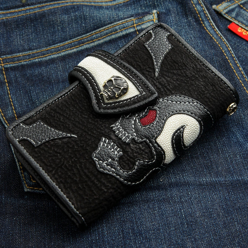 A premium custom handcrafted black leather skull wallet with a fiery red stingray eye and a solid sterling silver skull concho.