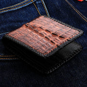 A premium dark brown crocodile biker wallet with intricate, hand-braided edges and a sterling silver chain grommet.
