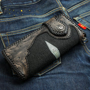 A hand-tooled leather and stingray biker wallet featuring a large, solid sterling silver dragon concho.