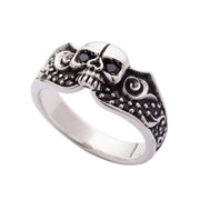A gothic skull wedding ring in solid sterling silver, featuring a central skull and a band adorned with black pavé stones.