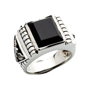 A men's solid sterling silver signet ring featuring a large black onyx stone and carved American eagle emblems.