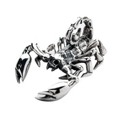 An angled close-up of the solid silver scorpion pendant, showing its three-dimensional design and polished pincers.