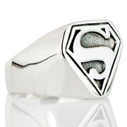 A solid sterling silver Superman ring featuring the iconic 'S' shield logo with a polished and textured finish.