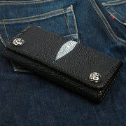 A premium trifold stingray biker wallet in black leather, featuring ornate solid sterling silver snaps and a white pearl mark.