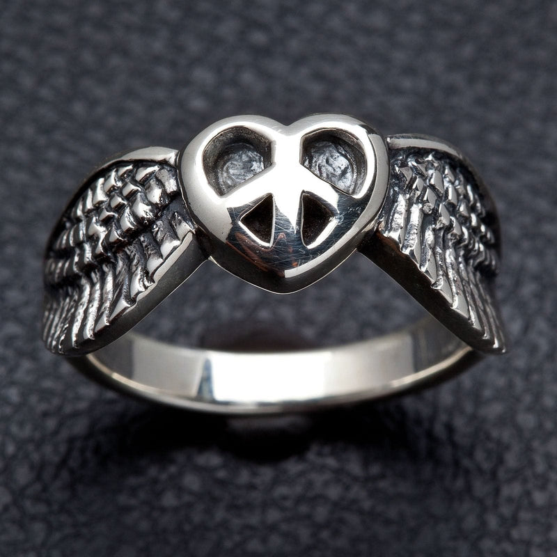 A unisex solid sterling silver ring featuring a winged heart with a peace sign in the center.